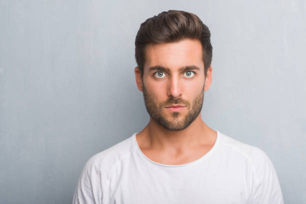 istock Handsome young man over grey grunge wall with a confident expression on smart face thinking serious 1069183612