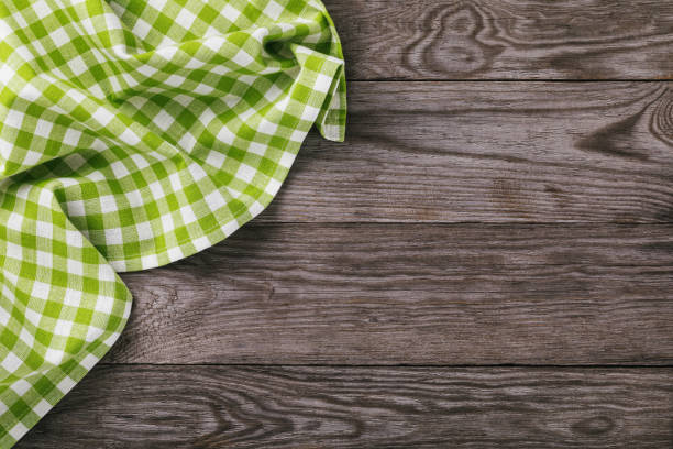 istock Top view on a multi-colored napkin on the left side of a wooden table with copy space 1069183812