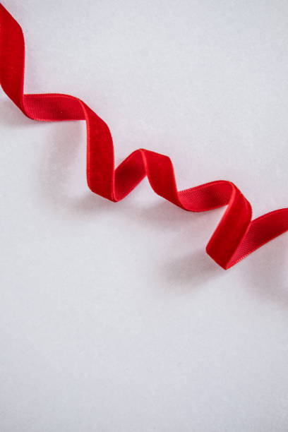 Red velvet curled ribbon on white