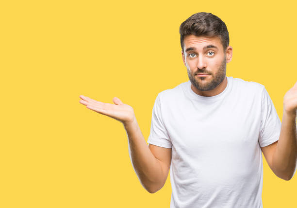 istock Young handsome man over isolated background clueless and confused expression with arms and hands raised. Doubt concept. 1069188068