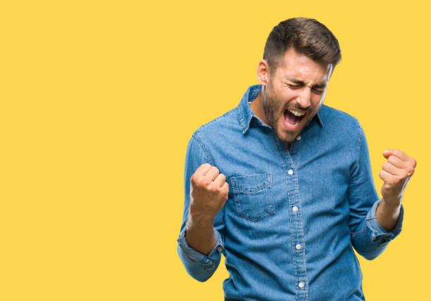 istock Young handsome man over isolated background very happy and excited doing winner gesture with arms raised, smiling and screaming for success. Celebration concept. 1069188142