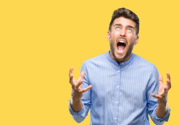 istock Young handsome man over isolated background crazy and mad shouting and yelling with aggressive expression and arms raised. Frustration concept. 1069188188