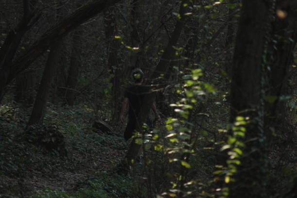 istock Rear view on a woman walking in forest 1069188202