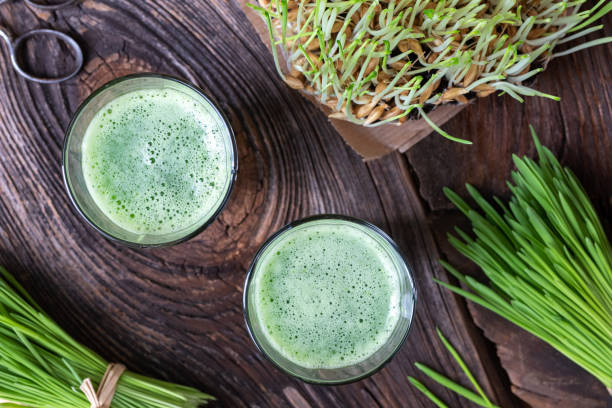 istock Barley grass juice with freshly harvested barley grass 1069188234