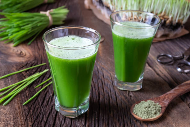 istock Barley grass juice with freshly harvested barley grass 1069188256