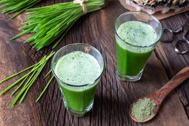 istock Barley grass juice with freshly harvested barley grass 1069188294
