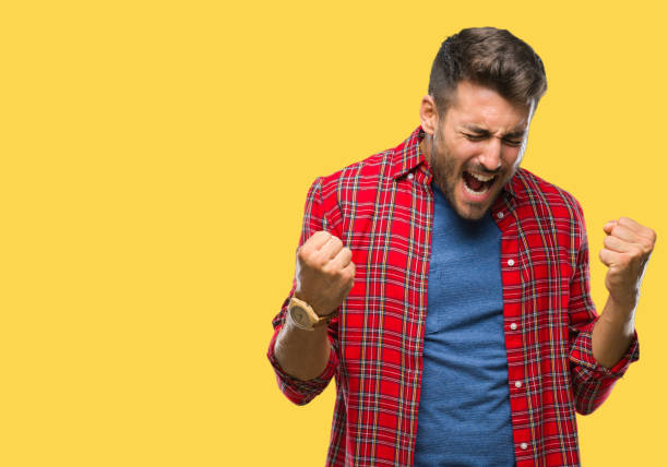 istock Young handsome man over isolated background very happy and excited doing winner gesture with arms raised, smiling and screaming for success. Celebration concept. 1069188346