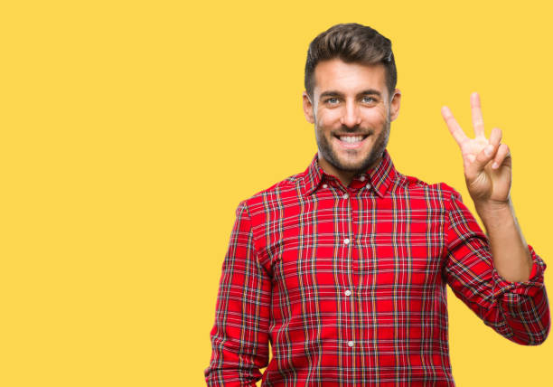 istock Young handsome man over isolated background showing and pointing up with fingers number two while smiling confident and happy. 1069188378
