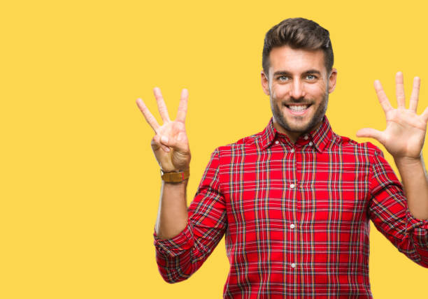 istock Young handsome man over isolated background showing and pointing up with fingers number eight while smiling confident and happy. 1069188380