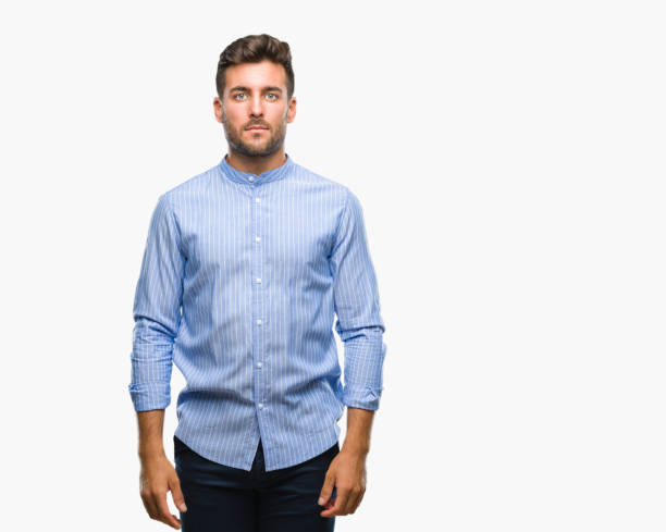istock Young handsome man over isolated background with serious expression on face. Simple and natural looking at the camera. 1069188958