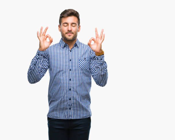 istock Young handsome man over isolated background relax and smiling with eyes closed doing meditation gesture with fingers. Yoga concept. 1069189346