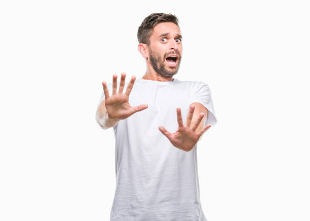 istock Young handsome man over isolated background afraid and terrified with fear expression stop gesture with hands, shouting in shock. Panic concept. 1069192856