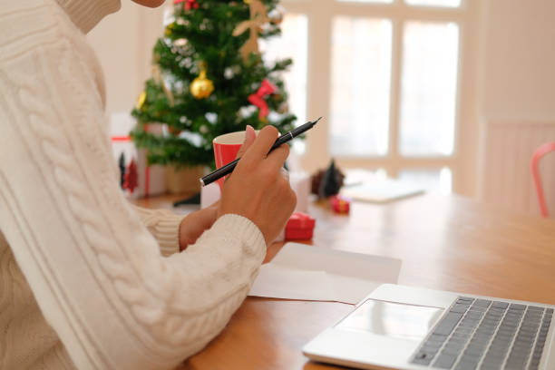 istock man holding coffee cup & using computer at home during christmas. xmas new year celebration 1069193238