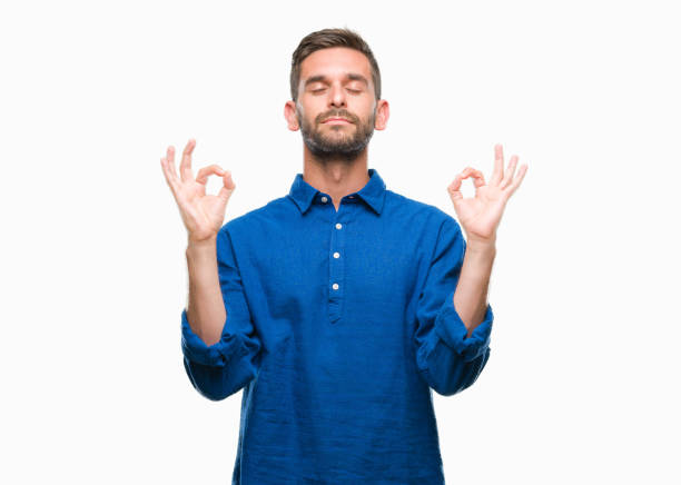istock Young handsome man over isolated background relax and smiling with eyes closed doing meditation gesture with fingers. Yoga concept. 1069193240
