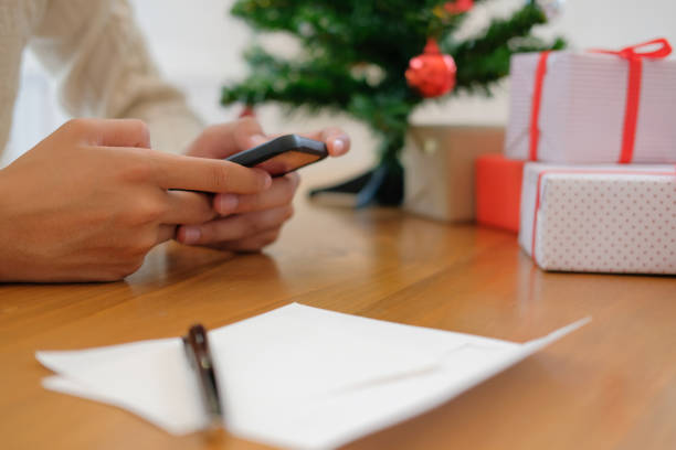 istock man using mobile smart phone with christmas decoration. xmas new year holiday celebration. 1069193302