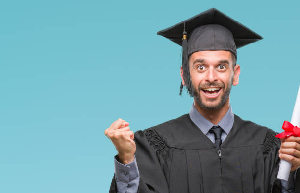 istock Young handsome graduated man holding degree over isolated background screaming proud and celebrating victory and success very excited, cheering emotion 1069193524