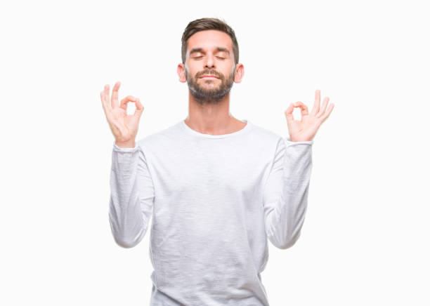 istock Young handsome man over isolated background relax and smiling with eyes closed doing meditation gesture with fingers. Yoga concept. 1069193564