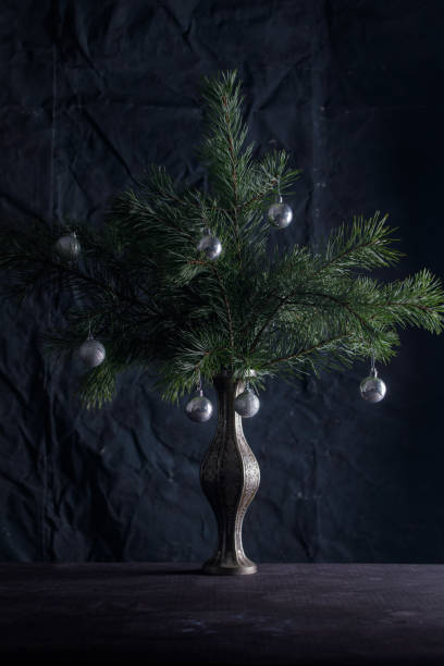 istock Decorated Christmas tree with silver balls. Unusual Christmas decoration ate in a vase. 1069204590