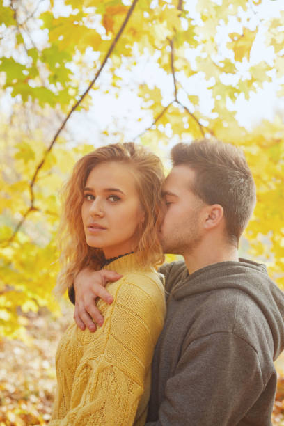istock Young couple in love in autumn forest 1069206988