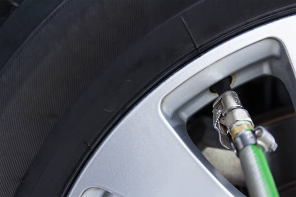 istock Pressure check and inflating car tire 1069208668
