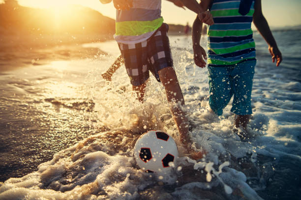 Salvador, Bahia Brazil - September 25, 2020: Young people playing soccer on Farol da Barra beach in full pandemic. Moment of liberated beaches to favor the local economy.