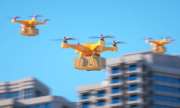 Three drones carrying a parcell stock photo