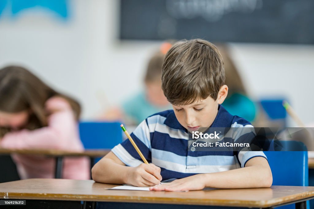 Boy Test Background Boy Taking A Test In Class Stock Photo - Download Image Now - 6-7 Years ...
