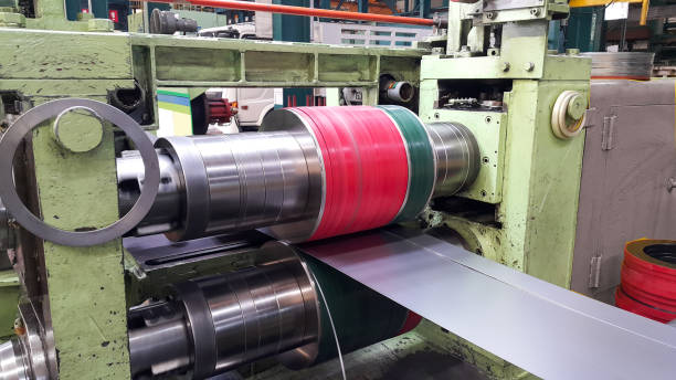 Rolled steel coil slitting process, slitter in factory warehouse, coil center Steel sheet in coil during slitting coating outer layer photos stock pictures, royalty-free photos & images