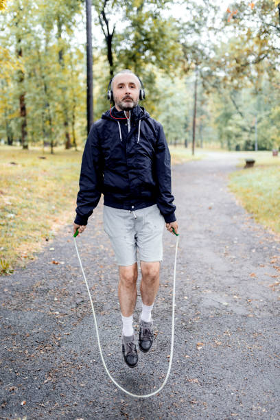 istock Mid Aged Man Exercising in Public Park 1069221508