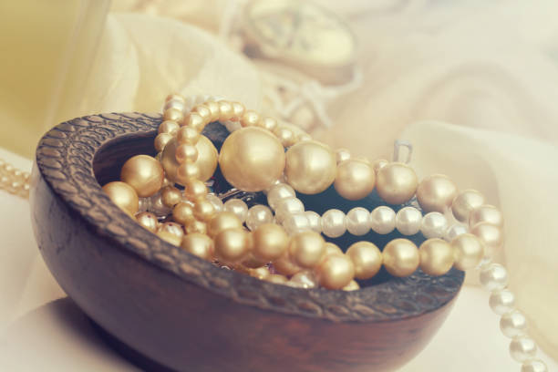 woman wearing pearl diamond necklace and wristband on white background