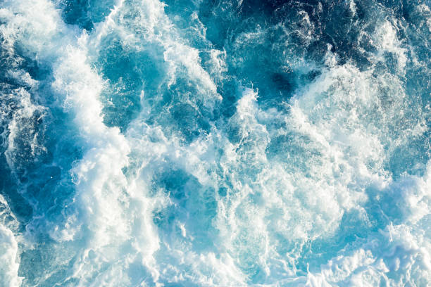 istock Spalsh of a blue sea water behind a ship. 1069228214