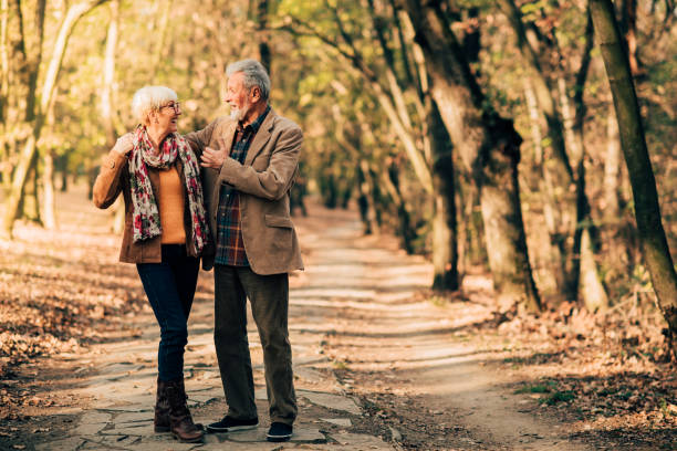 istock Happy couple walking in the park 1069228996