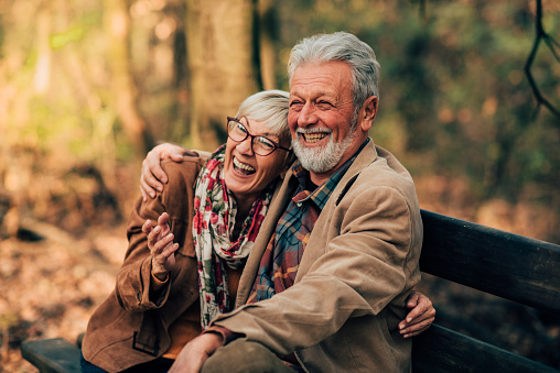 Happy old couple sitting on a bench