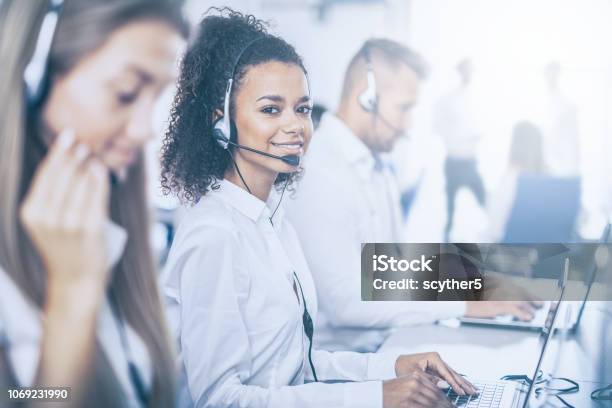 Call Center Worker Accompanied By Her Team Stock Photo - Download Image Now - Call Center, IT Support, Service