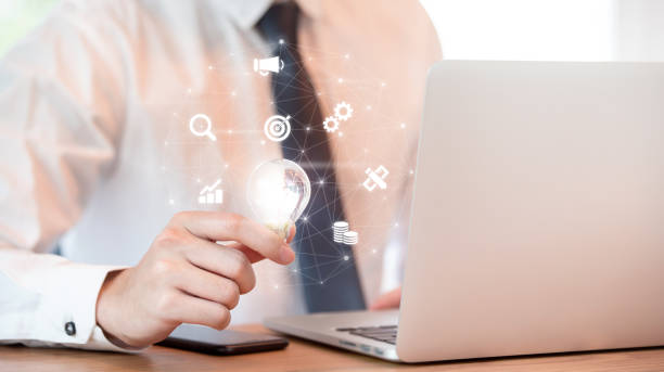 istock Businessman hand holding illuminated light bulb, brand idea concept. 1069234512