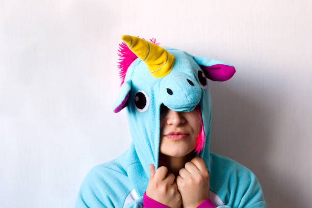 istock woman in unicorn costume 1069234630