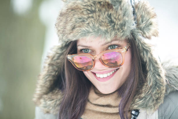 istock Young beautiful woman smiling outdoors in snow 1069235612
