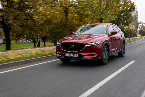New 2018 Mazda CX-5. Red CX-5 SUV car. Japanese car. Luxury transportation. Front view of the car in motion, speed.