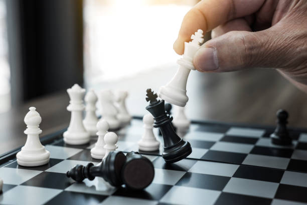istock Businessman's hand playing chess game to development analysis new strategy plan, business strategy leader and teamwork concept for win and success 1069238374