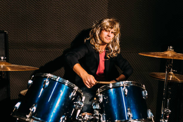 istock Male drummer wearing a blonde wig 1069238734
