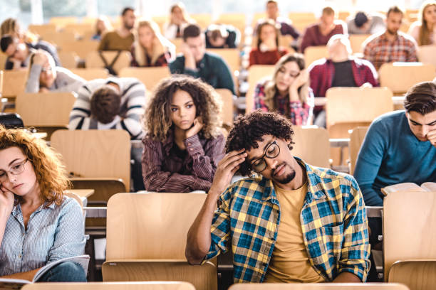 istock Large group of bored college students in a lecture hall. 1069239330