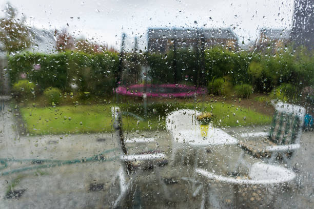 istock glass window with water raindrops looking in the garden with blurry effect autumn background 1069241494