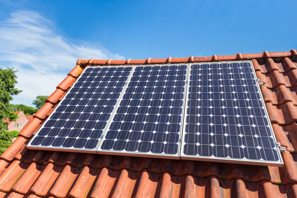 istock Row of solar panels  on orange house roof 1069244842