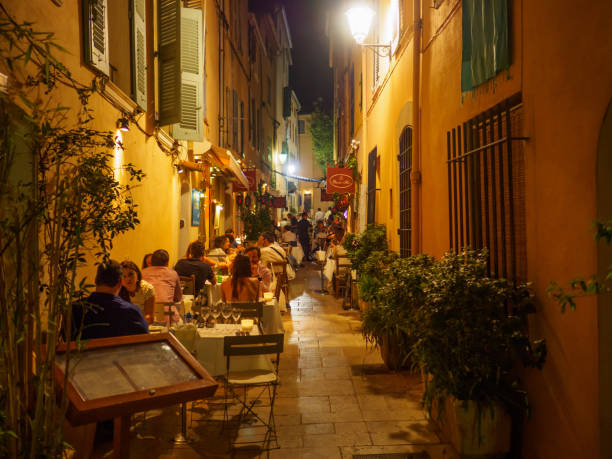 Saint Tropez, France - August 9 2017: Image of the tourists sitting at the terraces of the restaurants in Saint-Tropez during the evening.