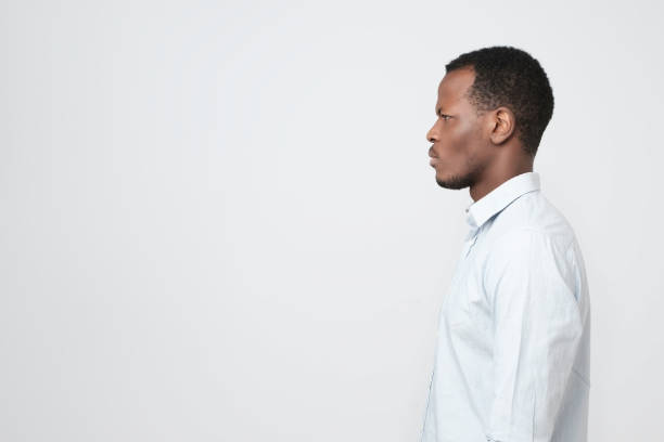 istock Side profile view portrait of smart african young man looking aside 1069245314