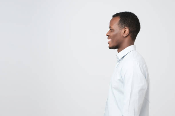 istock Side view of young happy african smiling man 1069245334