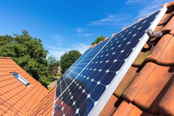 Row of solar panels  on roof at home Row of blue solar collectors  on orange roof of house. I took a photo of these solar collectors that are lying on my own roof in the netherlands. I can generate part of all the electricity that I need. On a sunny day in summer season I will get much electrical power. solar power station solar panel house solar energy stock pictures, royalty-free photos & images