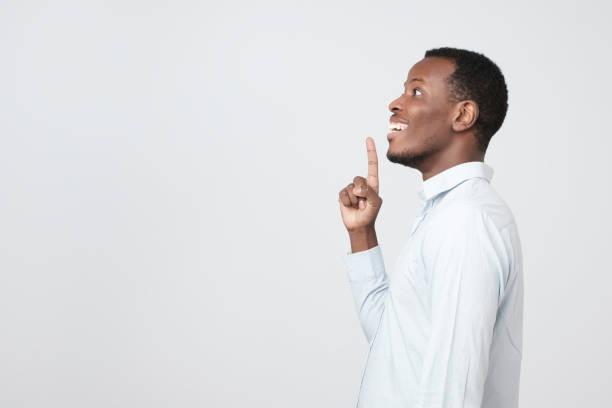 istock A side view of young handsome african man standing having excellent idea 1069245482