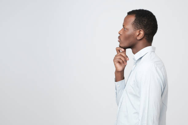 istock Profile of young african man concentrating having a thought. 1069245500