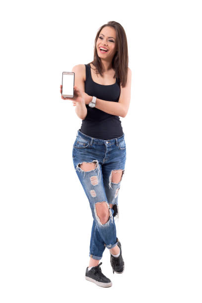 istock Young beautiful modern woman laughing and showing blank mobile phone screen. 1069248764